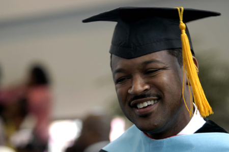 An education graduate flashes a big smile after summer graduation. - Photo by Kathleen Murray
