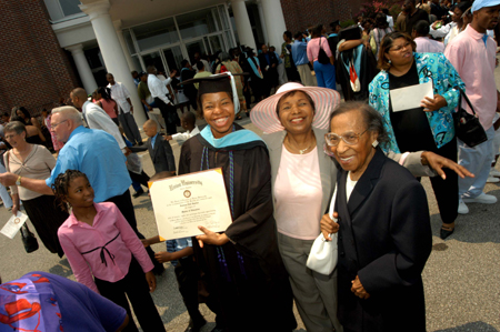 Master of Education graduate Jannina Gaston poses with friends and family after receiving her degree at summer graduation. - Photo by Morris Abernathy