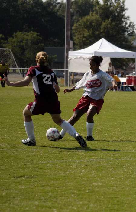 Cynthia Medina, sophomore, makes a move on a Freed-Hardeman defender during Union's scrimmage. - Photo by Kathleen Murray