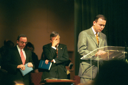 Minister to the University Todd Brady speaks with God before Chuck Colson brings his chapel address. - Photo by Jim Veneman