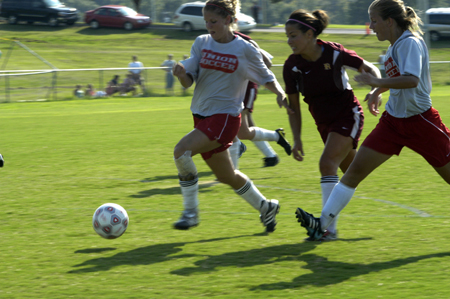Sophomore Lauren Williams and Freshman Emily Rawls defend the ball as a Freed-Hardeman play makes pursuit. - Photo by Kathleen Murray