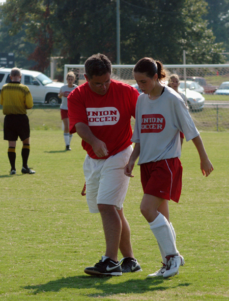 Coach Boylan takes a minute to give Forward Nikki Burau some pointers during Union's scrimmage versus Freed-Hardeman. - Photo by Morris Abernathy