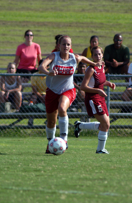 Senior Kari Bachman chases the ball as a defender looks on. - Photo by Morris Abernathy