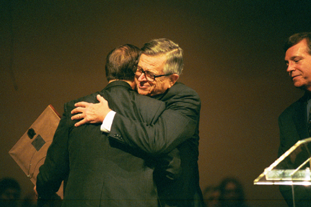 Chuck Colson embraces Dr. Hal Poe after Poe was named the Chuck Colson Chair of Faith and Culture. - Photo by Jim Veneman