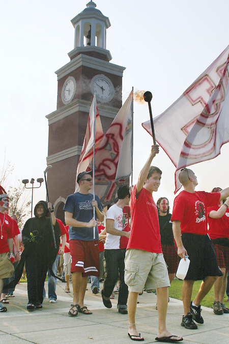 Senior Brad Spencer, biology major and student body president, leads the mass of pep rally attenders to the soccer games.They were the first home games of the season. - Photo by Kyle Kurlick