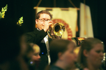 Senior Jeremy Scott plays trumpet for the Symphonic Band during the Chuck Colson chapel service. - Photo by Jim Veneman