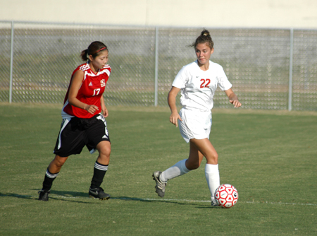 Charity Carter (22) attempts to keep the ball from a Martin Methodist player. - Photo by Steven Aldridge