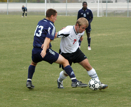 Sophomre Craig Clark battles with a Missouri Baptist player for ball possesion in Union's win. - Photo by Steven Aldridge