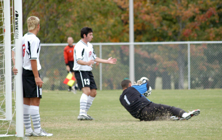 Senior goalie Robert Stinson saves a corner kick shot during Union's 4-1 win over Missouri Baptist University.  Vagner Oliveira (21) and Chris Prentice (18) back him up. - Photo by Steven Aldridge