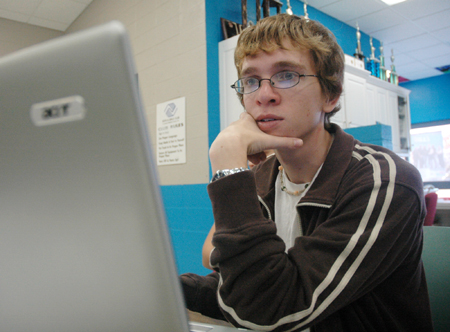 Junior Josh Shrewsberry assists the Boys and Girls Club of Jackson in compiling results from a survey during the Day of Remembrance. - Photo by Brad Moore