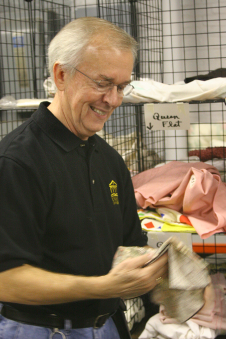 Wayne Johnson, associate professor of communiation arts, separated clothing at RIFA during Alpha Psi Omega's Day of Remembrance service project. - Photo by Derek Ownby