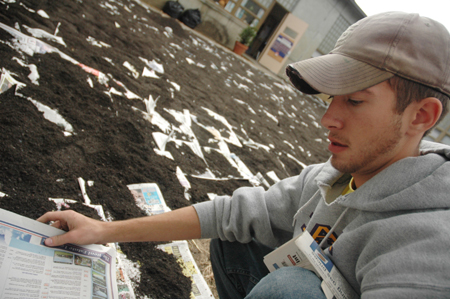 Senior Nathan Morris helped level and mulch space for a peace garden at Parkview Montessori during his Day of Remembrance service project. - Photo by Kristen Nicole Sayres
