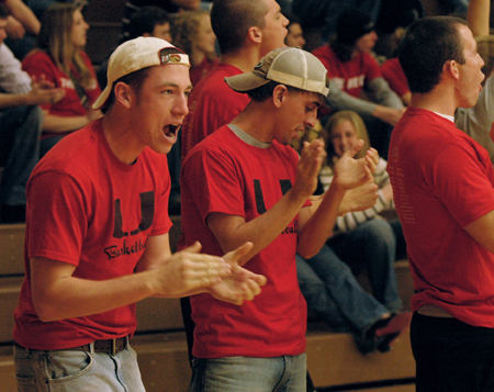 Freshman Chris Rains and Sophomore Mickey Armstrong cheer with fellow Lambda Chi Alpha members during a close basketball game against Oklahoma City University. - Photo by Brad Moore