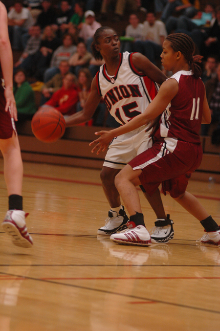 Latorya Fuller (15) looks for an open teammate as she is guarded by a Southern Nazarene player duing the Jackson Rotary Classic.  Union won the game 94-62. - Photo by Kristen Nicole Sayres