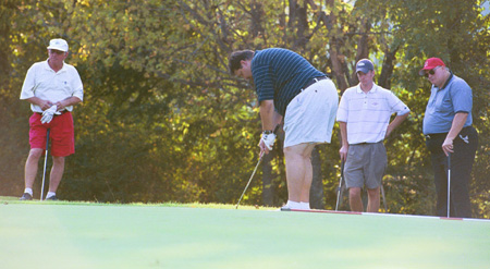 Union University Day at Shiloh Ridge provided an opportunity for Union alum and prospective students to enjoy a round of golf with members of Union's golf team.  Here alum Eric Barron puts while Ned Boston, Union golfer Caleb Walker, Alan Damron and watch. - Photo by Justin Veneman
