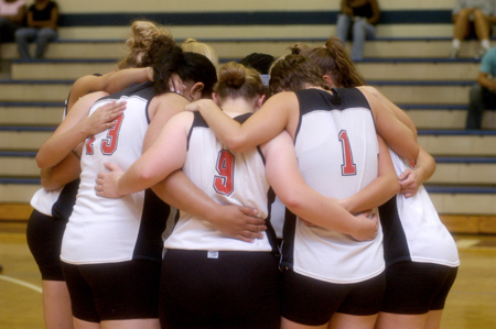 The Union University volleyball team huddles one last time prior to the start of a match at Lambuth.  Union won the match 3-2. - Photo by Brad Moore