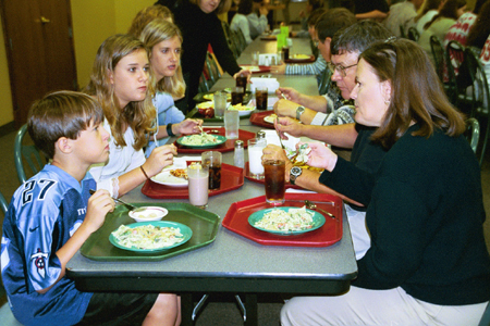 Freshman Emily Boecking enjoys a meal together with her family during Family Weekend 2002.
 - Photo by Lindsay Stavish