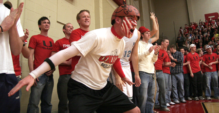Freshman Chase Raines leads the cheers from behind the baseline during the Bulldogs' home game against Lambuth. - Photo by Kyle Kurlick