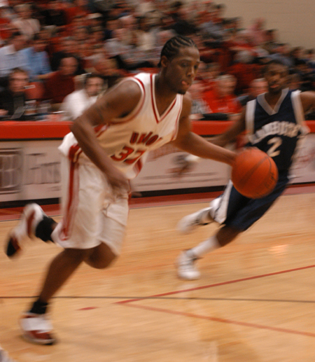 Mack Bealim (32) plays keep-away from a Lambuth defender in Union 85-75 win. - Photo by Heather Phillips