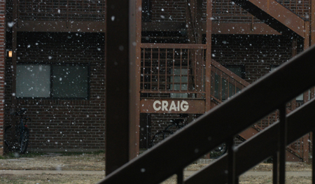 Large snowflakes falling outside the Craig building in the McAfee Residence Complex. - Photo by Heather Phillips