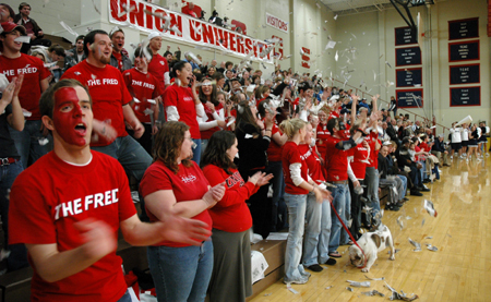 Students celebrate the first Union basket of the game with confetti and cheering. - Photo by Brad Moore