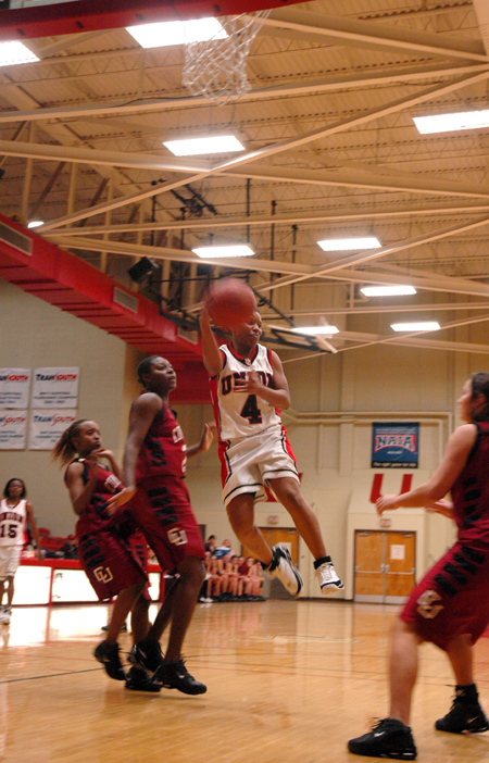 Freshman Jessica Graves (4) makes a pass while in the air in a game versus Cumberland.  - Photo by Brad Moore