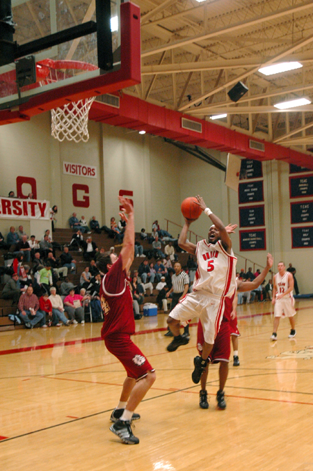 Marcus Cooper (5) goes up for the jumpshot while being guarded by two Cumberland defenders.   - Photo by Brad Moore