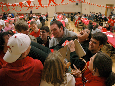 A group of students help Freshman Hannah Holliday celebrate her birthday at the World's Largest Tailgate Party. - Photo by Brad Moore