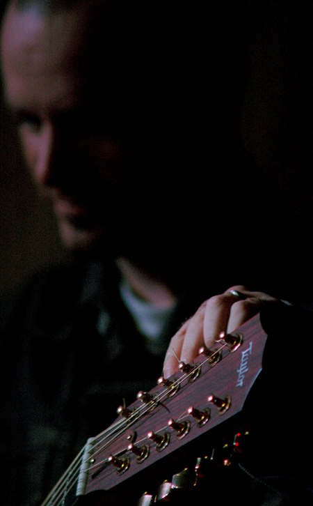 Derek Webb makes sure his guitar is tuned just right before singing at the Homecoming Coffeehouse. - Photo by Kristen Nicole Sayres