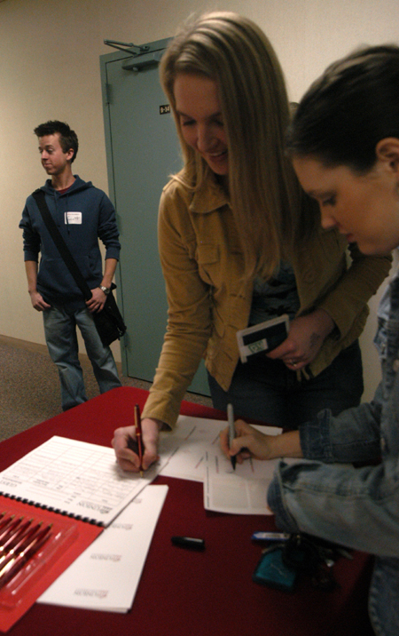 Chemistry majors Jennifer Hamman and Kimberly Lindsey sign in at the Alumni Conference on the Sciences, an annual Homecoming event. - Photo by Heather Phillips