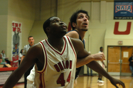 Junior center Pierry Valmera (44) blocks out a Mountain State (W. Va.) player in Union's win during Homecoming 2006.  - Photo by Heather Phillips