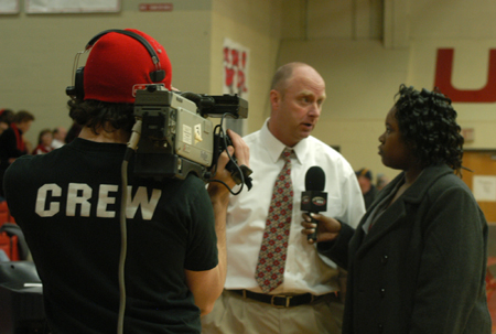 UBS Reporter Tosheia Cole with Wes Calvert on camera interviews Coach Turner following the Homecoming game against Mountain State. - Photo by Heather Phillips
