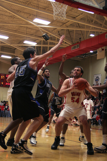 Junior center Ben Frederick finds himself surounded by Mountain State defenders, however, Frederick and the Bulldogs came away with this Homecoming victory. - Photo by Kyle Kurlick