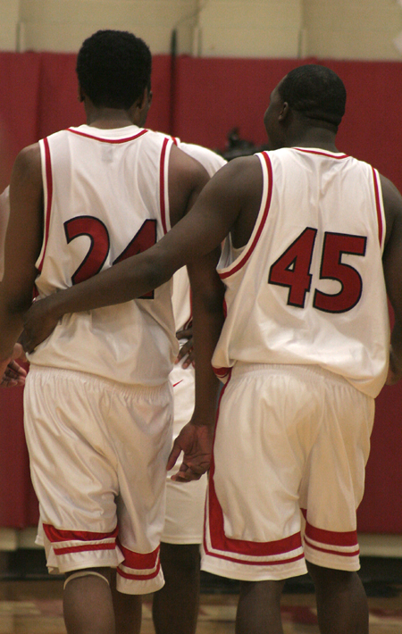 Deywane Lee (24) and Corey Burkett (45) huddle up with teammates during a home game at The Fred.
 - Photo by Kyle Kurlick