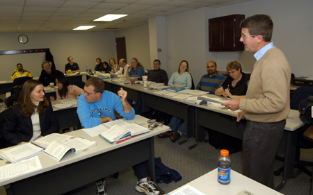 Howard Newell, university professor of business administration, leads an MBA class on the Germantown campus. - Photo by Morris Abernathy