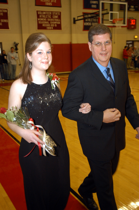Senior Annie Ross, a social work major from Anna, Ill., is escroted by her father Darrell Ross in the Homecoming Court processional.  - Photo by Morris Abernathy