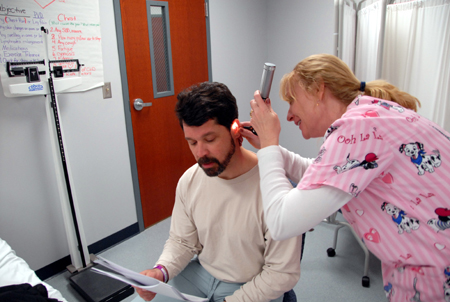RN-BSN Student Rosemary Jacob examines fellow student James Magness during a nursing class on the Germantown campus. 
 - Photo by Morris Abernathy