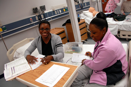 Nursing students review their notes during a class in the nursing lab on the Germantown campus. - Photo by Morris Abernathy