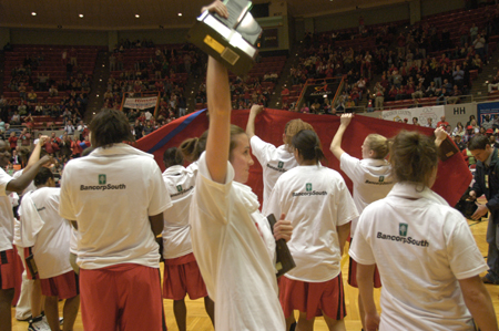 Senior guard Peggy McCain joins her Lady Bulldog teammates in celebrating a second consecutive NAIA national basketball championship. - Photo by Jim Veneman