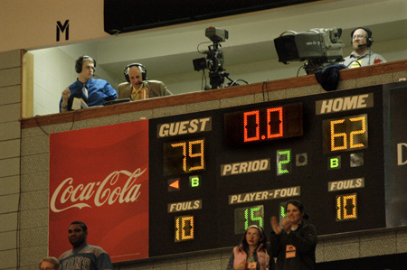As Union's broadcast team surveys the floor of Oman Arena, the scoreboard tells the story of the Lady Bulldogs' championship victory. - Photo by Jim Veneman