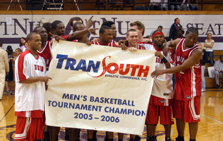 The Union men's basketball teams celebrates with their championhip banner following Union's second straight TranSouth Tournament Title.  This marked their fifth championship in the 10-year history of the conference. - Photo by Steven Aldridge