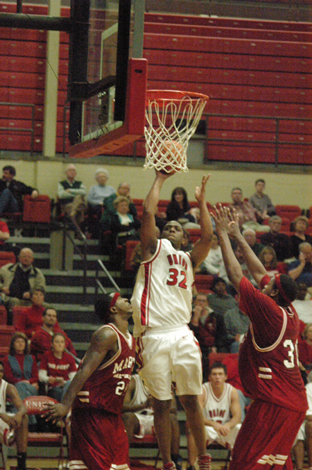 Mack Bealim (32) takes a short jumper over two Martin Methodist defenders in the Bulldog win. - Photo by Steven Aldridge