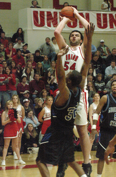 Junior center Ben Frederick (54) takes a shot over a Mountain State defender in front of a packed house at Union Fred DeLay Gymnasium. - Photo by Steven Aldridge