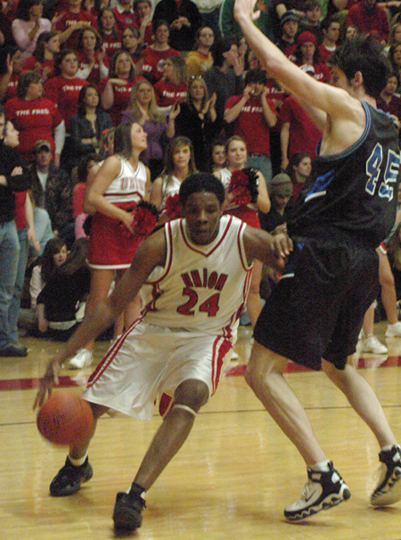 Junior forward Deywane Lee (24) drives past a Mountain State defender in front of a packed student section. - Photo by Steven Aldridge