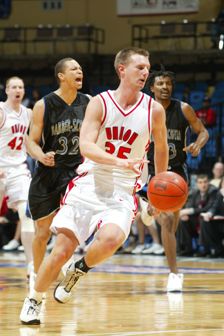 Matt Trammell turns back up the floor after as steal in Union's first round game in the NAIA National Tournament. - Photo by Uncredited