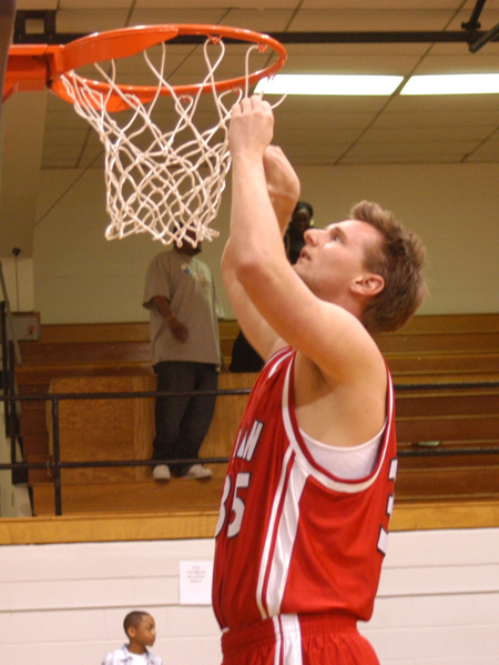 Senior guard Matt Trammell cuts down a piece of the net following Union's second straight TranSouth Tournament Title as they topped Trevecca Nazarene in the championship game.  - Photo by Steven Aldridge