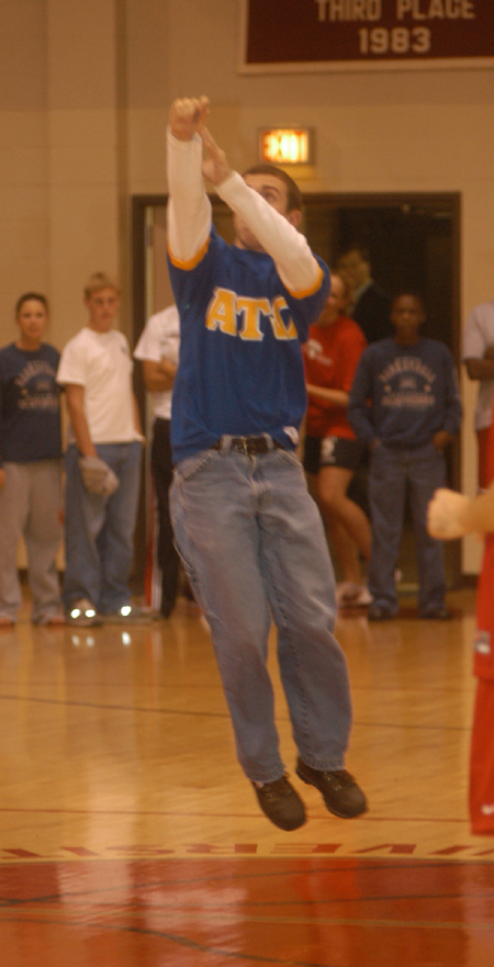 Jason Vaughn takes a half-court shot in order to win tuition for a whole semester.  Unfortunately, he missed. - Photo by Jim Veneman