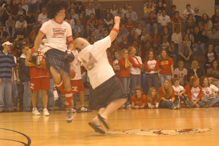John Reed knocks Jonathan Blair down as part of the Onions crazy fan competition performance during Midnight Madness. - Photo by Jim Veneman