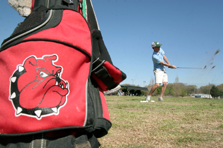Sophomore Mickey Armstrong, sports management major, works on his accuracy while he hits golf balls at various ranges. Each team member performed the excerise for Coach Morris at practice. - Photo by Kyle Kurlick