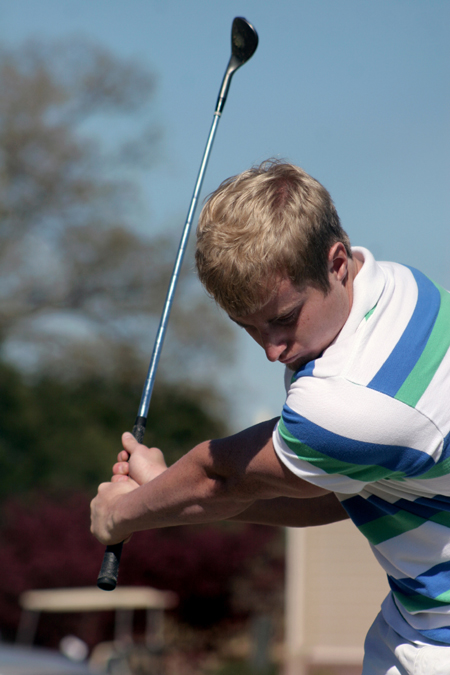 Matthew Honeycutt keeps his eye on the ball during his golf swing in a team practice. - Photo by Kyle Kurlick